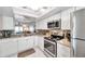 Bright kitchen featuring granite counters and stainless steel appliances at 460 Paula S Dr # 101, Dunedin, FL 34698
