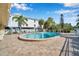 Community pool with lounge chairs and covered seating area at 460 Paula S Dr # 101, Dunedin, FL 34698