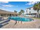 Community pool with lounge chairs and covered seating area at 460 Paula S Dr # 101, Dunedin, FL 34698
