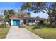 Charming single story home with teal garage door and landscaping at 5301 16Th N Ave, St Petersburg, FL 33710