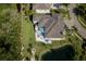 Overhead view of the home showing the large pond, lush landscaping, and proximity to the golf course at 5951 Bay Dr, Gulfport, FL 33707