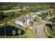 Aerial view of the property showing the pond, landscaping, and proximity to the golf course at 5951 Bay Dr, Gulfport, FL 33707