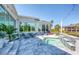 The backyard features a pool with a waterfall feature, along with ample seating at 5951 Bay Dr, Gulfport, FL 33707