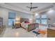 Inviting bedroom with fan, neutral tones, marble floors, and soft natural light at 5951 Bay Dr, Gulfport, FL 33707