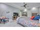 Comfortable bedroom with a cozy chair, TV, ceiling fan, and a bright and welcoming atmosphere at 5951 Bay Dr, Gulfport, FL 33707