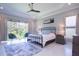 Main bedroom with a metal frame bed and large windows at 5951 Bay Dr, Gulfport, FL 33707