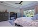 Spacious bedroom with large window, ceiling fan, and stylish furnishings, perfect for relaxation and comfort at 5951 Bay Dr, Gulfport, FL 33707