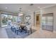 Elegant dining room with a modern chandelier, large windows, and a stainless steel refrigerator at 5951 Bay Dr, Gulfport, FL 33707