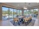 Bright dining room features floor-to-ceiling windows with scenic backyard and pool views at 5951 Bay Dr, Gulfport, FL 33707