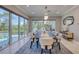 Bright dining room with large windows and a view of the outdoor pool and patio area at 5951 Bay Dr, Gulfport, FL 33707