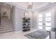 Bright foyer features staircase, light fixture, decor, and entry doors with sidelights at 5951 Bay Dr, Gulfport, FL 33707