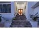 Elegant stairs leading to double doors with potted plants at 5951 Bay Dr, Gulfport, FL 33707