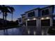 Stunning modern home exterior with double garage at dusk at 5951 Bay Dr, Gulfport, FL 33707