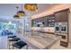 Large kitchen island with marble countertops, gold fixtures, and stainless steel appliances at 5951 Bay Dr, Gulfport, FL 33707