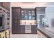 Modern kitchen boasts built-in wine storage, marble countertops, and stylish dark wood cabinetry at 5951 Bay Dr, Gulfport, FL 33707