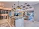 Open concept kitchen with marble countertops, stainless steel appliances, and seamless flow to the living room at 5951 Bay Dr, Gulfport, FL 33707