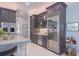 Modern kitchen with dark cabinetry, wine cooler and stainless steel appliances at 5951 Bay Dr, Gulfport, FL 33707