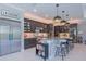 Spacious gourmet kitchen features dark wood cabinets, stainless steel appliances, and marble countertops with bar seating at 5951 Bay Dr, Gulfport, FL 33707