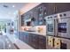 Modern kitchen with dark cabinetry and stainless steel appliances at 5951 Bay Dr, Gulfport, FL 33707