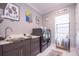 Well-organized laundry room with marble countertop sink and modern washer and dryer at 5951 Bay Dr, Gulfport, FL 33707
