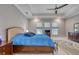 Bright main bedroom featuring a ceiling fan, tray ceiling, large windows and an en-suite bathroom at 5951 Bay Dr, Gulfport, FL 33707