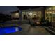 Evening view of a backyard patio with a fire pit and pool at 5951 Bay Dr, Gulfport, FL 33707