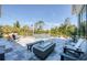 Relaxing backyard with pool, spa, lounge chairs, and outdoor fire pit on a well-maintained stone patio at 5951 Bay Dr, Gulfport, FL 33707