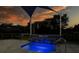 Relaxing spa with waterfall feature at twilight at 5951 Bay Dr, Gulfport, FL 33707