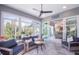 Bright sunroom with comfortable seating and access to outdoors at 5951 Bay Dr, Gulfport, FL 33707