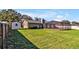 Expansive backyard with screen-enclosed pool, storage shed, and well-manicured lawn at 7801 17Th N Way, St Petersburg, FL 33702