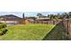 Spacious backyard featuring a screen enclosed pool, wood fence, and green lawn at 7801 17Th N Way, St Petersburg, FL 33702