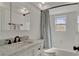 Bathroom featuring a white vanity, marble countertop, and tub at 7801 17Th N Way, St Petersburg, FL 33702