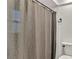 A bathroom features a shower/tub combo with a textured shower curtain and modern toilet at 7801 17Th N Way, St Petersburg, FL 33702
