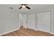 A bedroom featuring wood-look flooring, neutral paint and closet with bi-fold doors at 7801 17Th N Way, St Petersburg, FL 33702