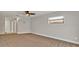 A bright bedroom features neutral carpet, ceiling fan, and access to other rooms at 7801 17Th N Way, St Petersburg, FL 33702