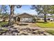 Tan house with mature landscaping and a two-car garage at 7801 17Th N Way, St Petersburg, FL 33702