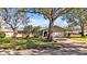 Charming single-story home featuring a well-manicured lawn, mature trees, and an attached two-car garage at 7801 17Th N Way, St Petersburg, FL 33702