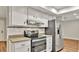 This eat-in kitchen offers stainless steel appliances, tiled backsplash and bright white cabinetry at 7801 17Th N Way, St Petersburg, FL 33702