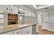 This eat-in kitchen features wood-look floors, stainless appliances, a peninsula counter, and stone fireplace at 7801 17Th N Way, St Petersburg, FL 33702