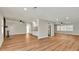 Open-concept living space with hardwood floors, seamlessly connecting the kitchen and living areas at 7801 17Th N Way, St Petersburg, FL 33702