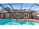 Inviting kidney-shaped pool with screened enclosure at 7801 17Th N Way, St Petersburg, FL 33702