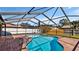 Screened-in pool area with brick pavers, featuring a relaxing space for swimming and lounging at 7801 17Th N Way, St Petersburg, FL 33702