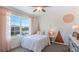 Bright bedroom with a white comforter and geometric accent wall at 8210 Dolphin Bluff Blvd, Wesley Chapel, FL 33545