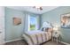 Charming bedroom with a white headboard and colorful striped bedding at 8210 Dolphin Bluff Blvd, Wesley Chapel, FL 33545