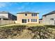 Spacious backyard with grassy lawn and two-story house at 1192 Multiflora Loop, Lutz, FL 33558