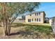 Large backyard with grassy area and a house at 1192 Multiflora Loop, Lutz, FL 33558
