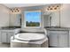 Bathroom with double vanity, garden tub and window at 1192 Multiflora Loop, Lutz, FL 33558