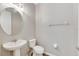 Simple bathroom with white pedestal sink and oval mirror at 1192 Multiflora Loop, Lutz, FL 33558