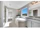 Spacious Primary bathroom with soaking tub, double vanity, and large window at 1192 Multiflora Loop, Lutz, FL 33558