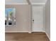 Light and airy entryway with hardwood floors and white door at 1192 Multiflora Loop, Lutz, FL 33558